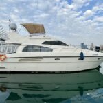 42FT yacht cruising from Dubai Harbour with city skyline in the background